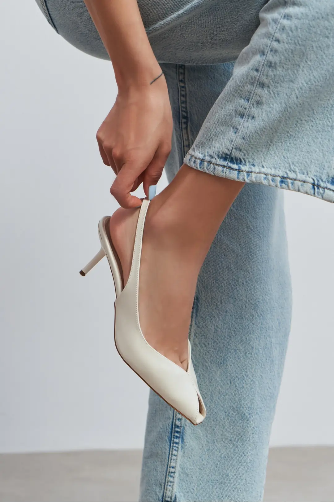 An Eloria Shoes ivory slingback, worn